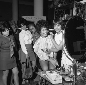 Flori Roberts Cosmetics makeup artist demonstrating products to women, Los Angeles, 1970. 